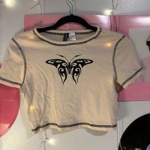 💗tan crop top with black abstract butterfly on front, black trimming